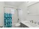 Bathroom featuring a shower/tub combo, large mirror, and neutral colors at 1705 Belleair Forest Dr # B, Belleair, FL 33756