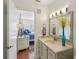 Bright bathroom featuring a vanity with marble countertop and views to the bedroom at 1705 Belleair Forest Dr # B, Belleair, FL 33756