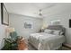 Bright bedroom features hardwood floors, neutral colors, ceiling fan, and lots of natural light at 1705 Belleair Forest Dr # B, Belleair, FL 33756