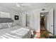 Bright bedroom featuring a ceiling fan, closet, neutral colors, and hardwood floors at 1705 Belleair Forest Dr # B, Belleair, FL 33756
