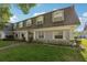 Well-kept condo exterior with a classic design and manicured lawn, showcasing curb appeal at 1705 Belleair Forest Dr # B, Belleair, FL 33756