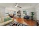 Spacious living and dining area with hardwood floors and large windows, blending style and comfort at 1705 Belleair Forest Dr # B, Belleair, FL 33756