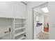 Pantry area with ample shelving and access to the kitchen at 1705 Belleair Forest Dr # B, Belleair, FL 33756