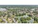 Breathtaking aerial shot of a community featuring abundant trees, a serene lake, and neatly arranged homes at 1705 Cinnabar Ct, Brandon, FL 33510