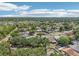 Extensive aerial view of a residential area dotted with trees and houses, bathed in sunlight and blue skies at 1705 Cinnabar Ct, Brandon, FL 33510