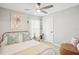 Cozy bedroom with neutral colors, ceiling fan, decorative pillows, side table, and ample natural light at 1705 Cinnabar Ct, Brandon, FL 33510