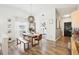 Dining area featuring wood floors, modern pendant lighting, and an open flow to kitchen at 1705 Cinnabar Ct, Brandon, FL 33510