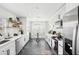 Modern kitchen with white cabinets, black marble floors, stainless steel appliances, and a breakfast nook at 1705 Cinnabar Ct, Brandon, FL 33510