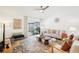 Bright living room with modern furnishings, a patterned rug, and a sliding glass door at 1705 Cinnabar Ct, Brandon, FL 33510