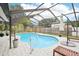 Sparkling pool surrounded by a screened enclosure, patio, and lush landscaping, perfect for outdoor enjoyment at 1705 Cinnabar Ct, Brandon, FL 33510