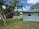 View of the side yard, showing the landscaping and small fence at 1713 Valencia E Dr, Largo, FL 33778