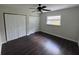 Bedroom with two large closets, dark wood floors and a ceiling fan at 1713 Valencia E Dr, Largo, FL 33778