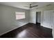 Bedroom showcasing wood floors, a window with blinds, and ample closet space at 1713 Valencia E Dr, Largo, FL 33778