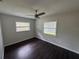 Well lit bedroom with wood floors, ceiling fan, and updated windows at 1713 Valencia E Dr, Largo, FL 33778
