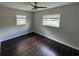 Bedroom with wood floors, two windows letting in natural light, and neutral paint at 1713 Valencia E Dr, Largo, FL 33778