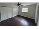 Bedroom with dark wood floors, ceiling fan and good natural light at 1713 Valencia E Dr, Largo, FL 33778
