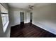 Bright bedroom featuring sleek dark wood flooring, closet with sliding doors, and a ceiling fan at 1713 Valencia E Dr, Largo, FL 33778