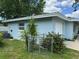 Exterior view of the home showcasing the well-maintained yard and blue paint at 1713 Valencia E Dr, Largo, FL 33778