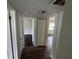 Hallway with doors leading to rooms with dark floors and natural light at 1713 Valencia E Dr, Largo, FL 33778