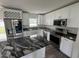 Modern kitchen features stainless steel appliances, granite countertops, and ample cabinet space at 1713 Valencia E Dr, Largo, FL 33778