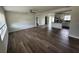 Open-concept living room and kitchen with hardwood floors, neutral paint, and a modern ceiling fan at 1713 Valencia E Dr, Largo, FL 33778