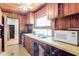 Rustic kitchen featuring wooden cabinets, vintage appliances, and a cozy atmosphere at 1778 27Th N Ave, St Petersburg, FL 33713