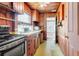 Cozy kitchen with wood cabinets, vintage appliances, and a view into the living room at 1778 27Th N Ave, St Petersburg, FL 33713