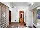 Spacious living room with wood floors, multiple doors, and a unique glass block feature at 1778 27Th N Ave, St Petersburg, FL 33713