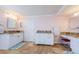 Bright bathroom featuring double vanities, granite countertops, and white cabinetry at 1860 N Fort Harrison Ave # 106, Clearwater, FL 33755