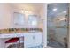 Bathroom featuring a walk-in shower, granite countertop vanity and pink walls at 1860 N Fort Harrison Ave # 106, Clearwater, FL 33755