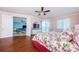 Bright bedroom featuring hardwood floors, balcony access, and view to the living room at 1860 N Fort Harrison Ave # 106, Clearwater, FL 33755