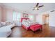 Bedroom with hardwood floors, an eye-catching painting, and a luxurious chaise lounge at 1860 N Fort Harrison Ave # 106, Clearwater, FL 33755
