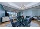 Open-concept dining area featuring stylish lighting, blue walls, and glass table, offering an inviting atmosphere at 1860 N Fort Harrison Ave # 106, Clearwater, FL 33755