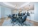 Bright dining area with stylish chandelier lighting, blue walls, counter seating and glass table at 1860 N Fort Harrison Ave # 106, Clearwater, FL 33755