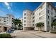 Exterior shot showcasing the building's architecture and landscaping, with a view of the covered parking area at 1860 N Fort Harrison Ave # 106, Clearwater, FL 33755