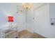 Elegant hallway featuring a chandelier, mirrored table, and an exit door and elevator at 1860 N Fort Harrison Ave # 106, Clearwater, FL 33755