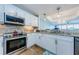 Modern kitchen with stainless steel appliances, granite countertops, and white cabinetry at 1860 N Fort Harrison Ave # 106, Clearwater, FL 33755