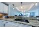 Granite countertop with a view of the living room and outside, offering a spacious and modern feel at 1860 N Fort Harrison Ave # 106, Clearwater, FL 33755