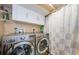 Functional laundry room equipped with modern washer and dryer units at 1860 N Fort Harrison Ave # 106, Clearwater, FL 33755