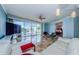 Bright living room with water views and open balcony, featuring tile floors and comfortable seating at 1860 N Fort Harrison Ave # 106, Clearwater, FL 33755