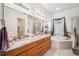 Luxurious bathroom featuring double sinks, granite counters, soaker tub and walk-in shower at 19750 Ellendale Dr, Land O Lakes, FL 34638