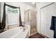Elegant bathroom featuring a soaker tub, walk-in shower, decorative tile and window at 19750 Ellendale Dr, Land O Lakes, FL 34638