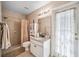 Bright bathroom with tiled shower, granite countertops, and access to the outdoors at 19750 Ellendale Dr, Land O Lakes, FL 34638