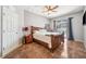 Comfortable bedroom featuring a wooden bed frame with a decorative quilt, and natural light at 19750 Ellendale Dr, Land O Lakes, FL 34638
