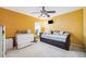 Bright bedroom features a ceiling fan, large windows, and a comfortable daybed at 19750 Ellendale Dr, Land O Lakes, FL 34638