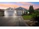 Charming single-story home featuring a two-car garage, well-manicured lawn, and a beautifully landscaped front yard at 19750 Ellendale Dr, Land O Lakes, FL 34638