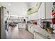 Modern kitchen with stainless appliances, tile backsplash, and open view to the living area at 19750 Ellendale Dr, Land O Lakes, FL 34638
