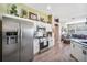 Bright kitchen featuring stainless steel appliances and white cabinetry, flowing into the living area at 19750 Ellendale Dr, Land O Lakes, FL 34638