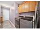 Convenient laundry room with modern washer and dryer units and ample storage space at 19750 Ellendale Dr, Land O Lakes, FL 34638
