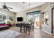 Open-concept living and dining area with sliding door, fan, and comfortable seating at 19750 Ellendale Dr, Land O Lakes, FL 34638